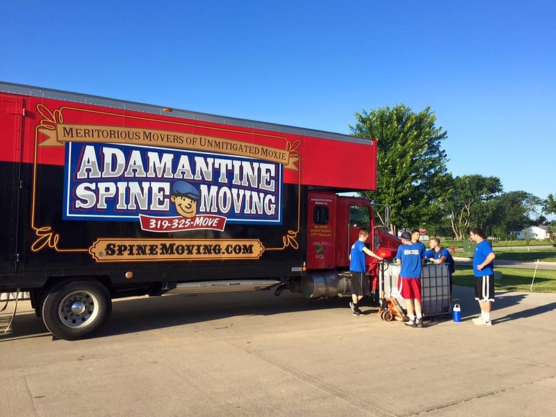 spine moving truck with movers in front