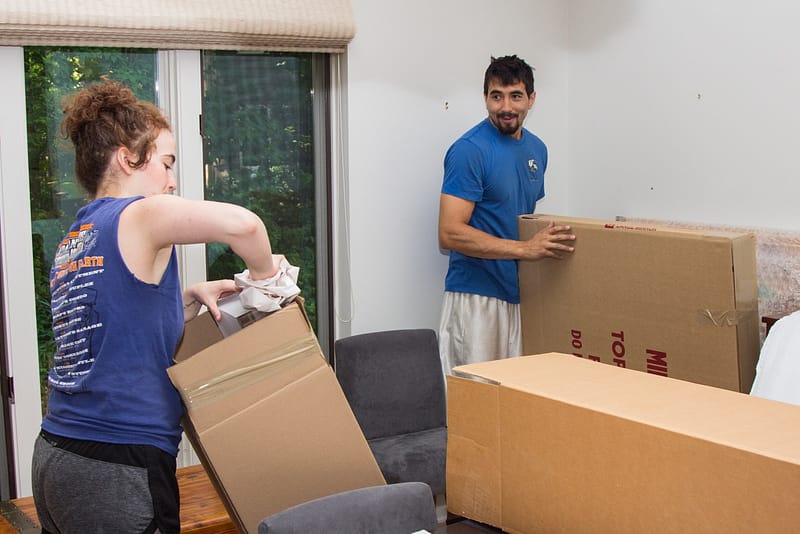 Spine movers unpackage boxes in new home