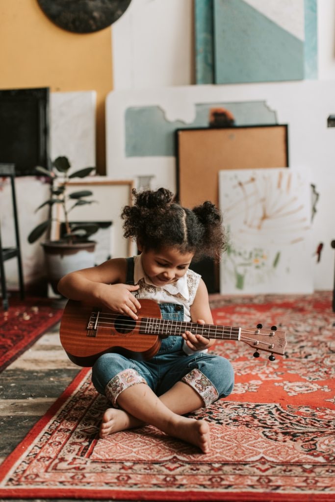 young girl playing guitar