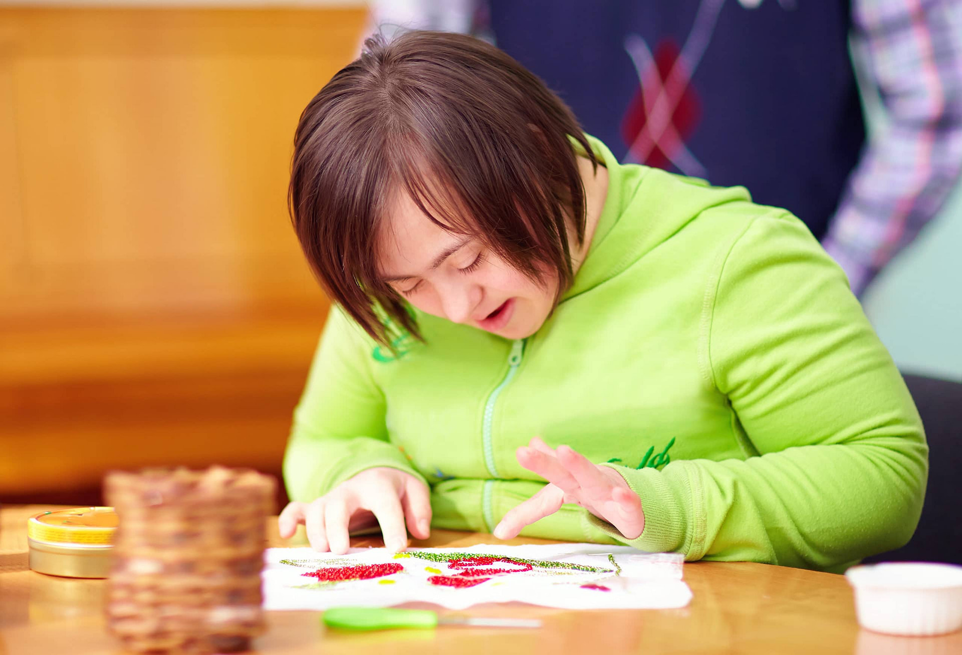 Young Adult Woman With Disability Engaged In Craftsmanship In Rehabilitation Center