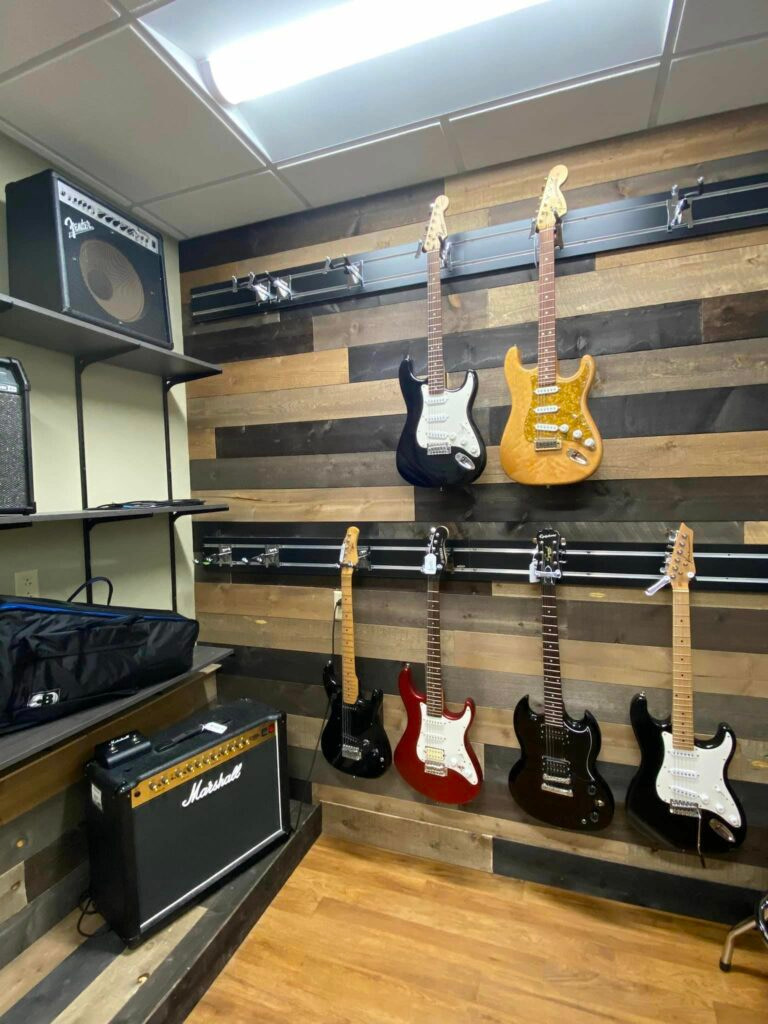 A room full of guitars and amplifiers.