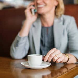 Woman Drinking Coffee Phone Midwestern Financial Fiduciary Early Investors