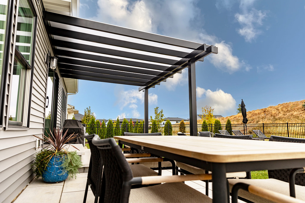 Black patio cover with white polycarbonate roof over a patio