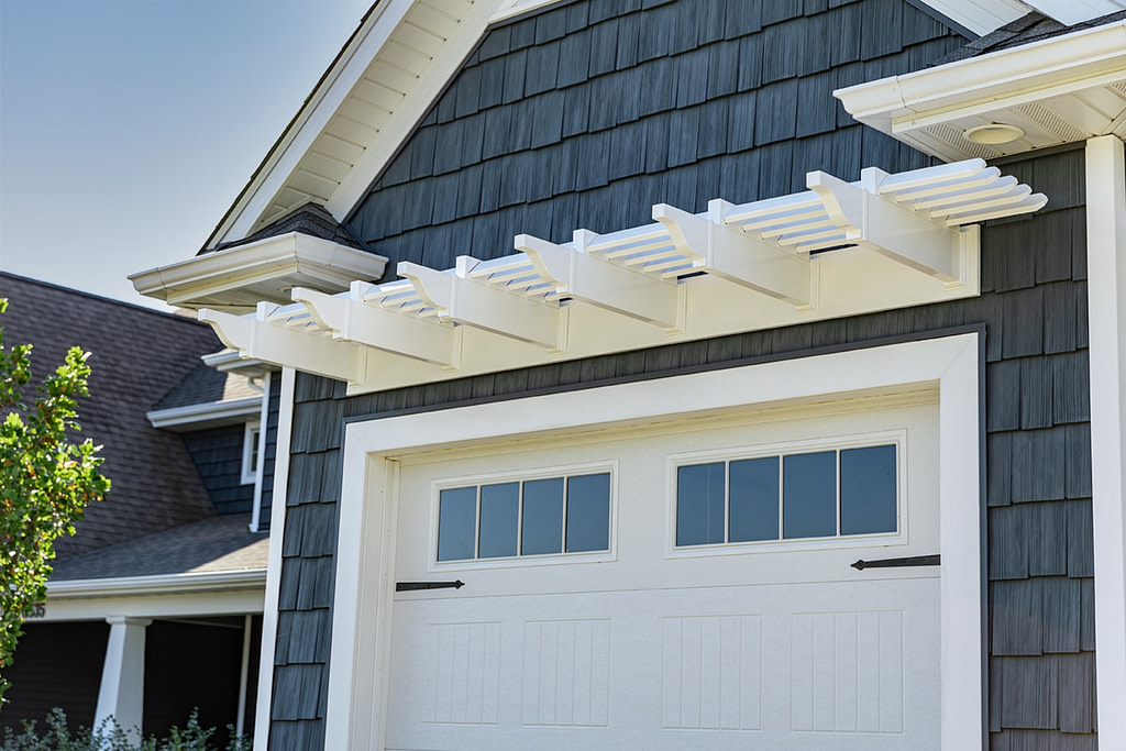 single garage door with white eyebrow pergola