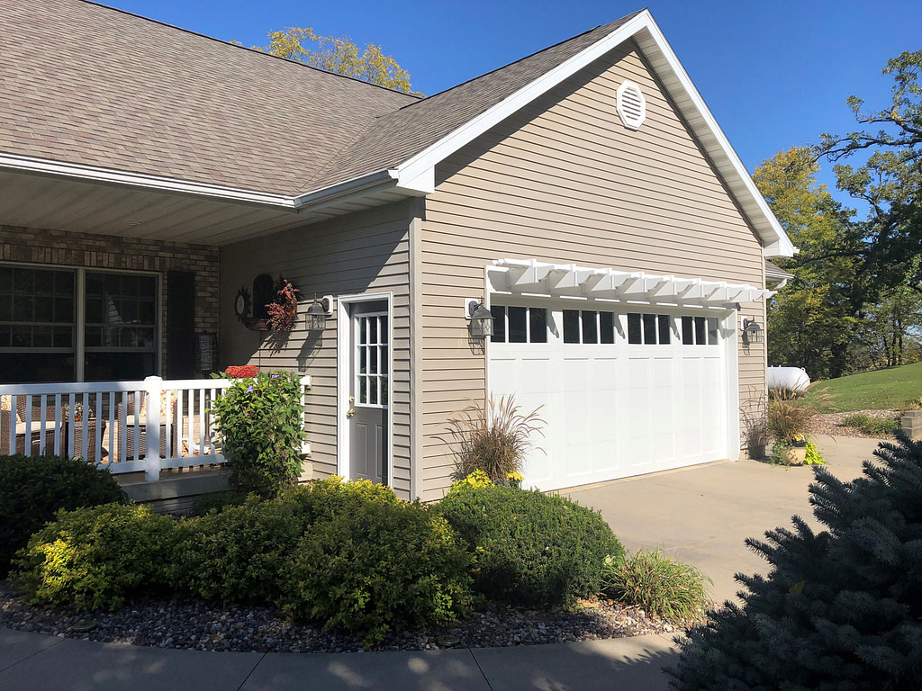 Side view of a garage door pergola