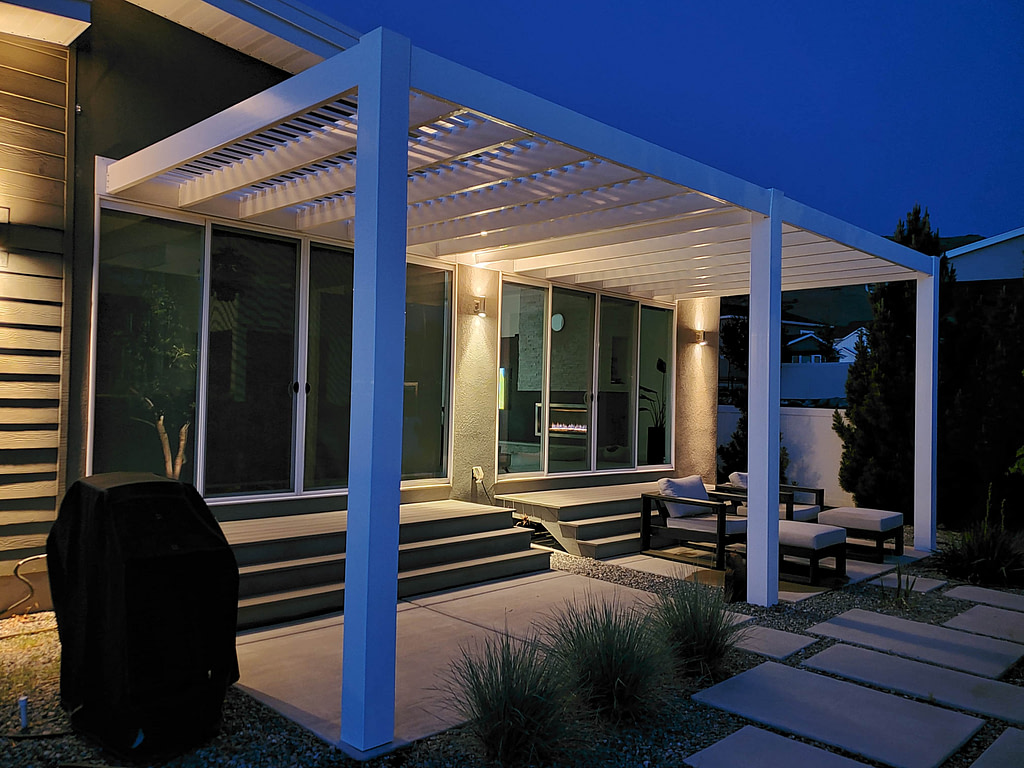Night view of a modern pergola lit up over a patio