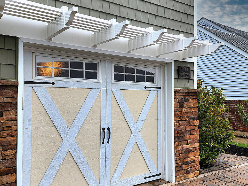 single garage door with white vinyl pergola