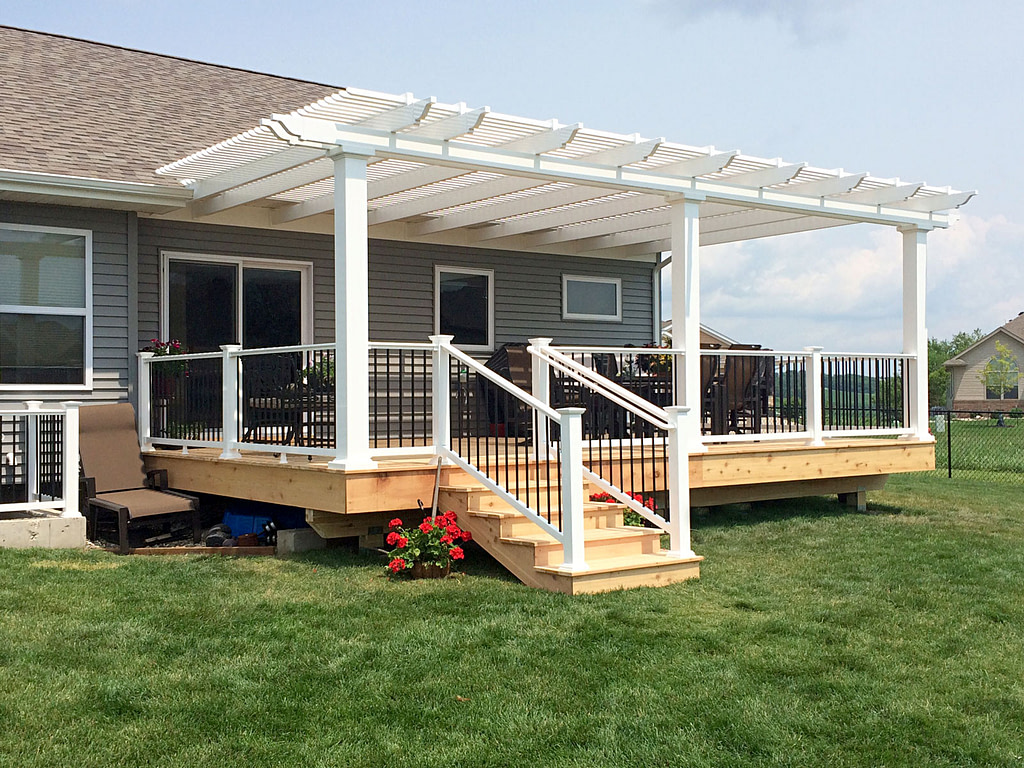 White vinyl attached pergola over a wood deck