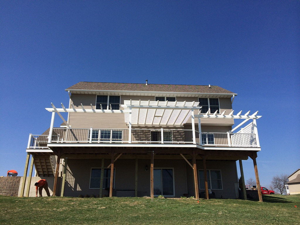 custom pergola with extending arbors on a raised deck