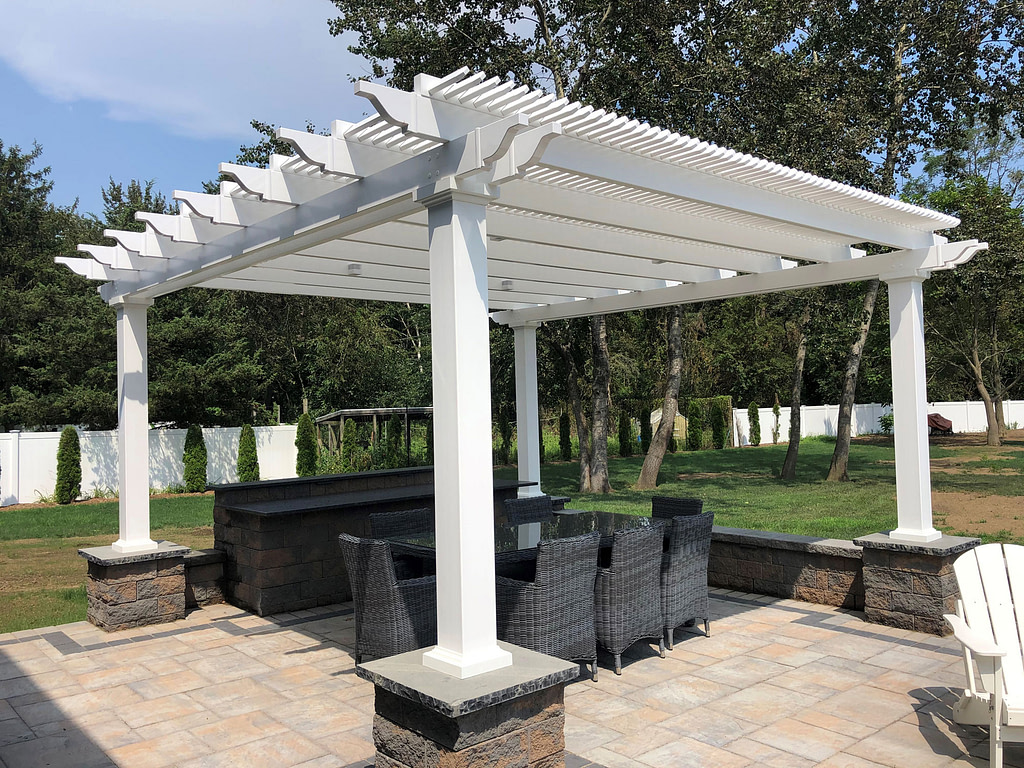 Freestanding shade pergola over a paver patio and dining area