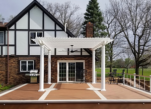 White pergola centered on a large deck