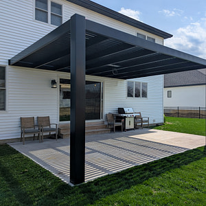 Elements rain proof pergola with solid roof panels installed over a patio