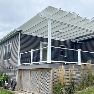 Traditional attached shade pergola mounted to a home exterior