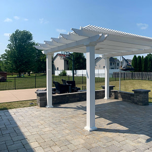 Traditional freestanding shade pergola in a backyard setting