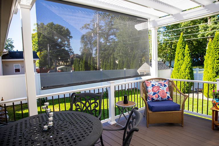 Pergola on a deck with pull down sun screen for additional shade