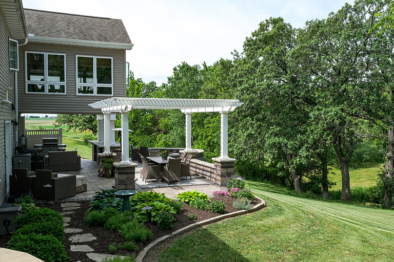 Freestanding pergola on nicely landscaped backyard