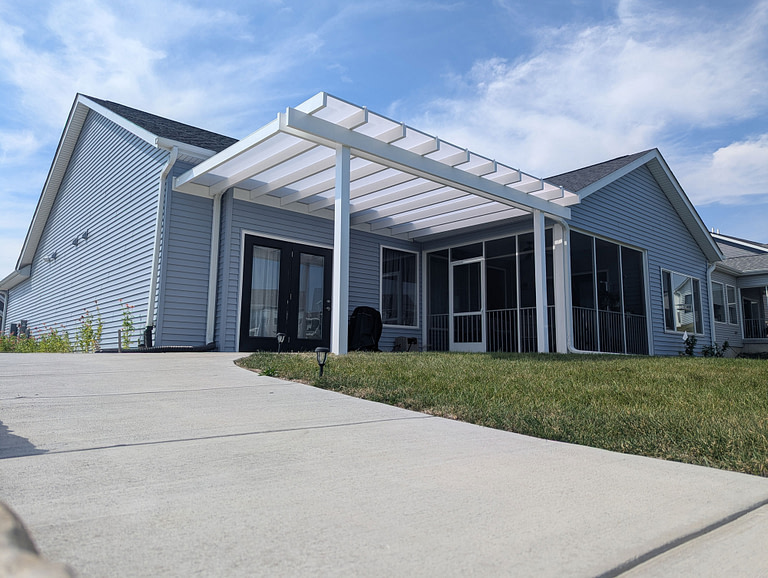 White covered pergola with white polycarbonate roof