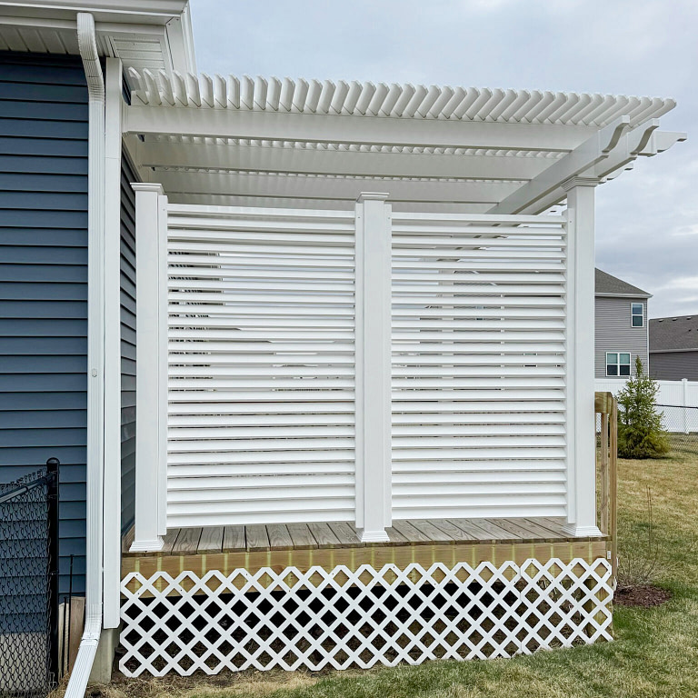 Vinyl Privacy Wall attached to pergola made from Heartland Pergola purlin materials