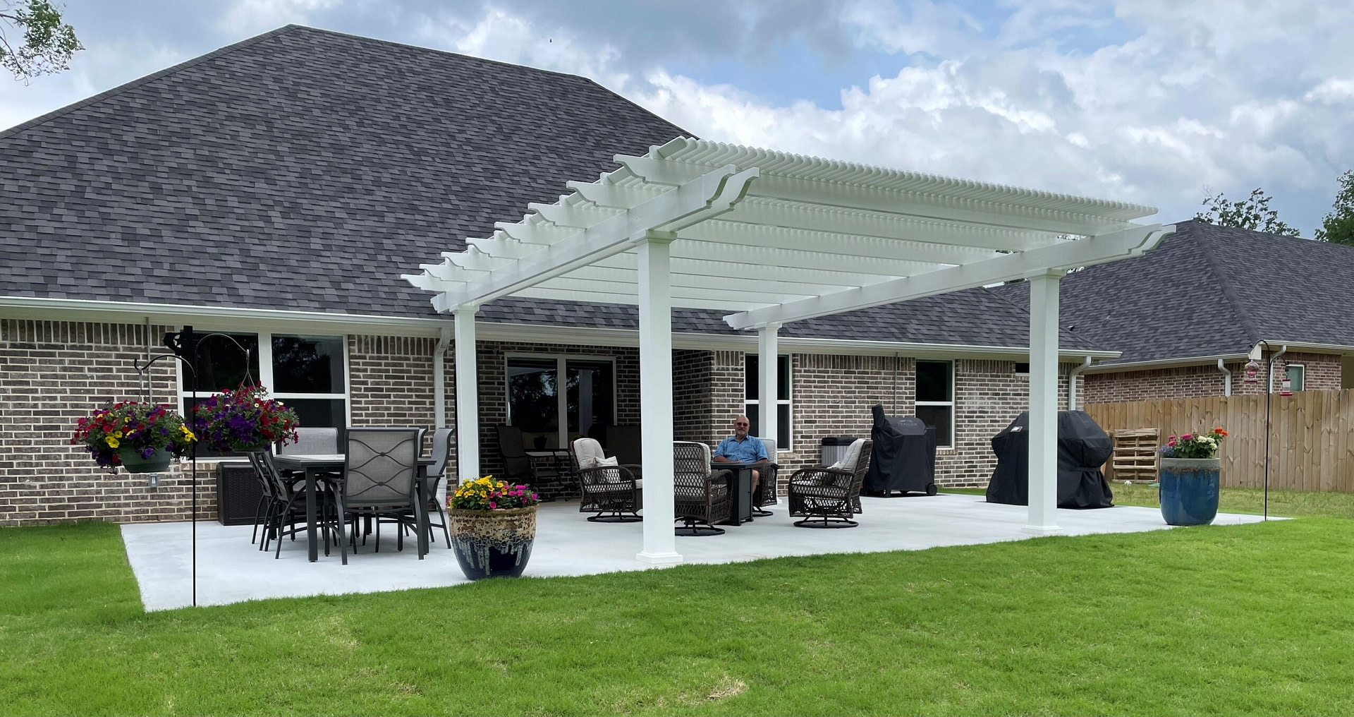 Man sitting underneath the Heartland vinyl pergola he built at his Texas home.