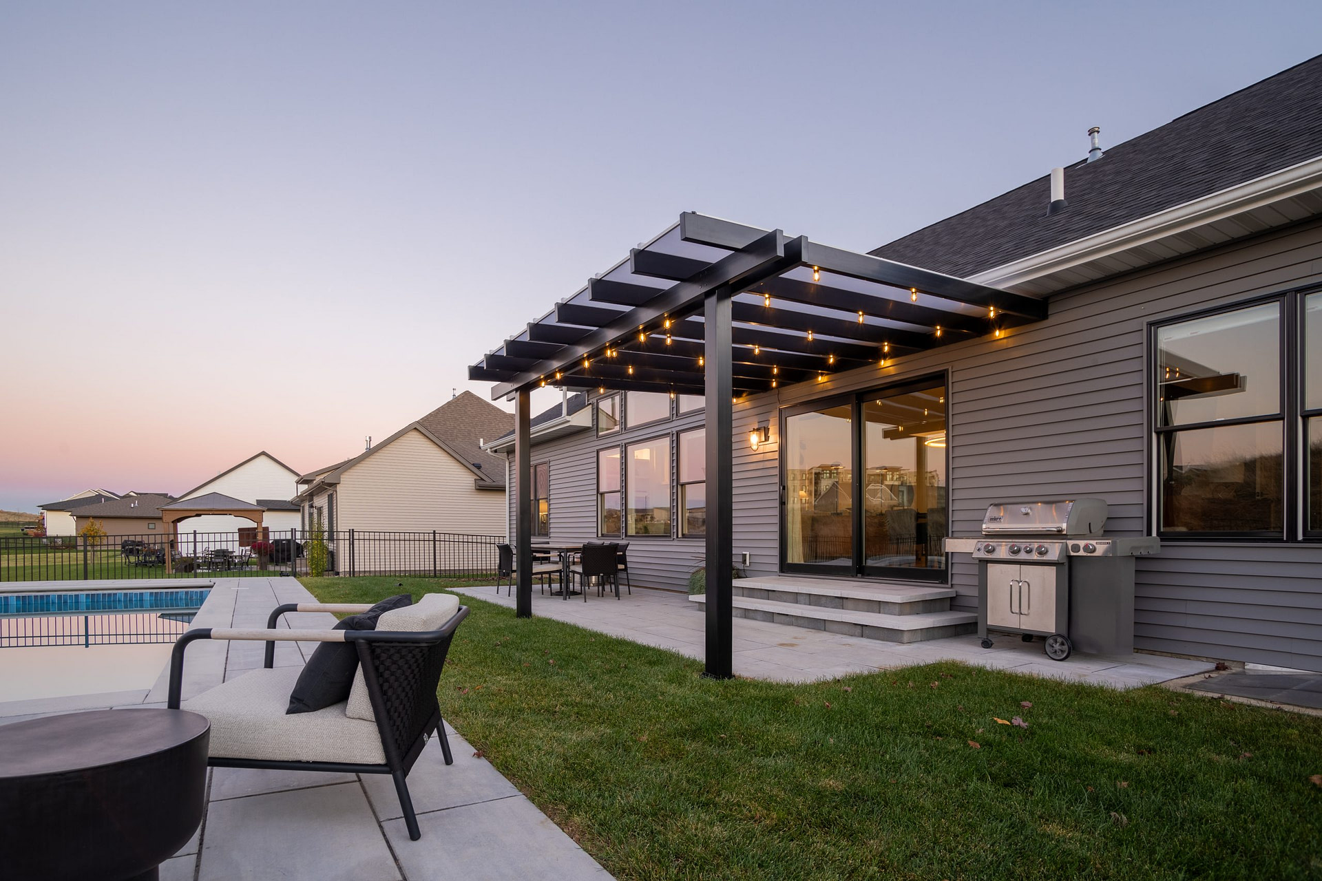 Rain Proof covered pergola over a patio at sunset