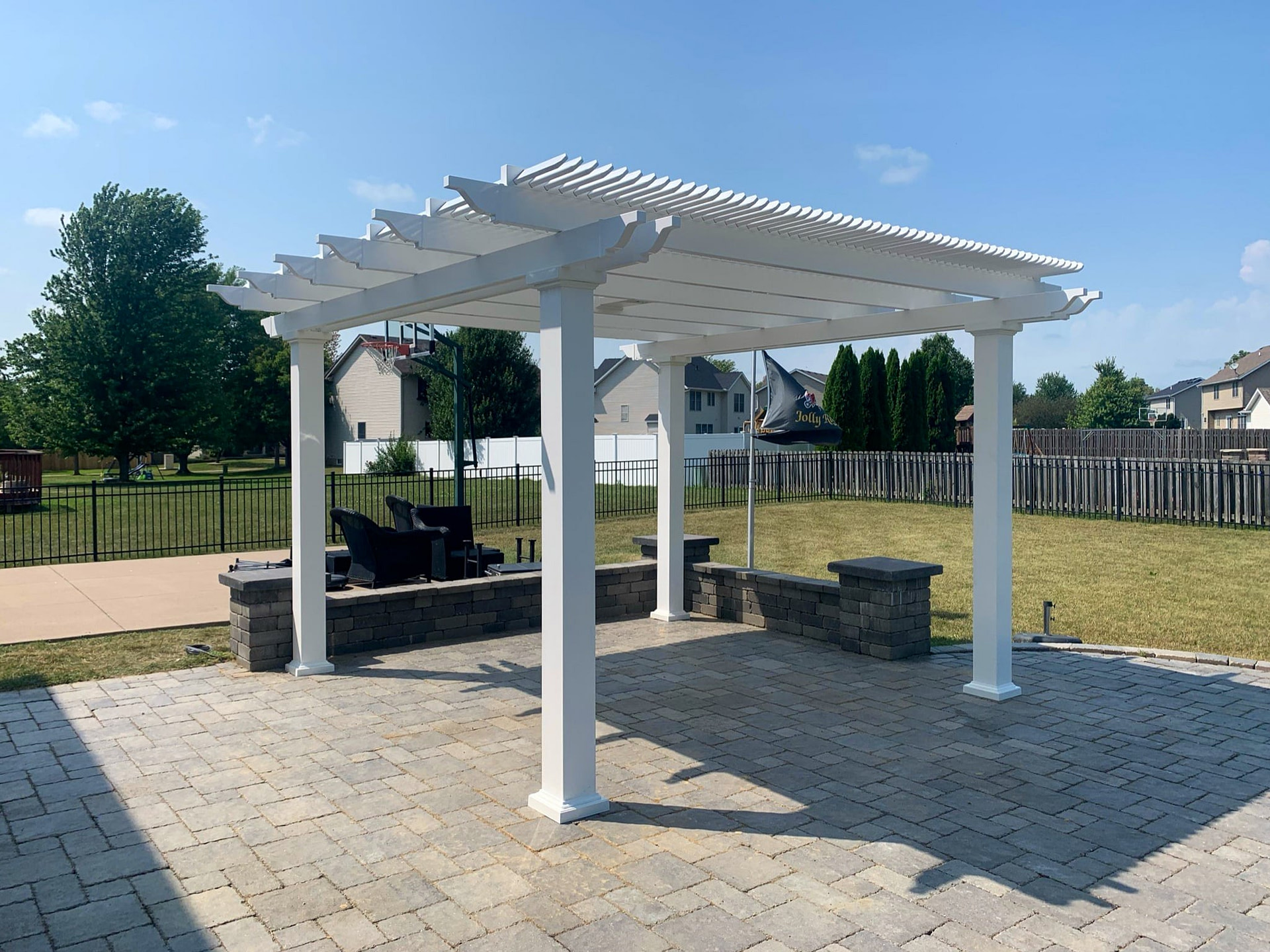Traditional freestanding shade pergola in a backyard setting