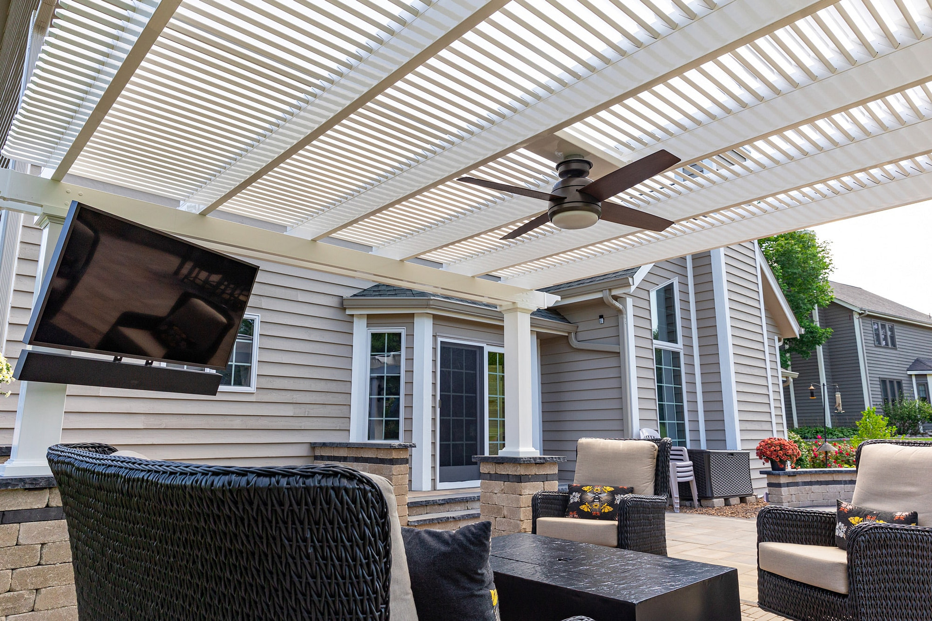 underside of outdoor pergola with fan and tv for patio seating