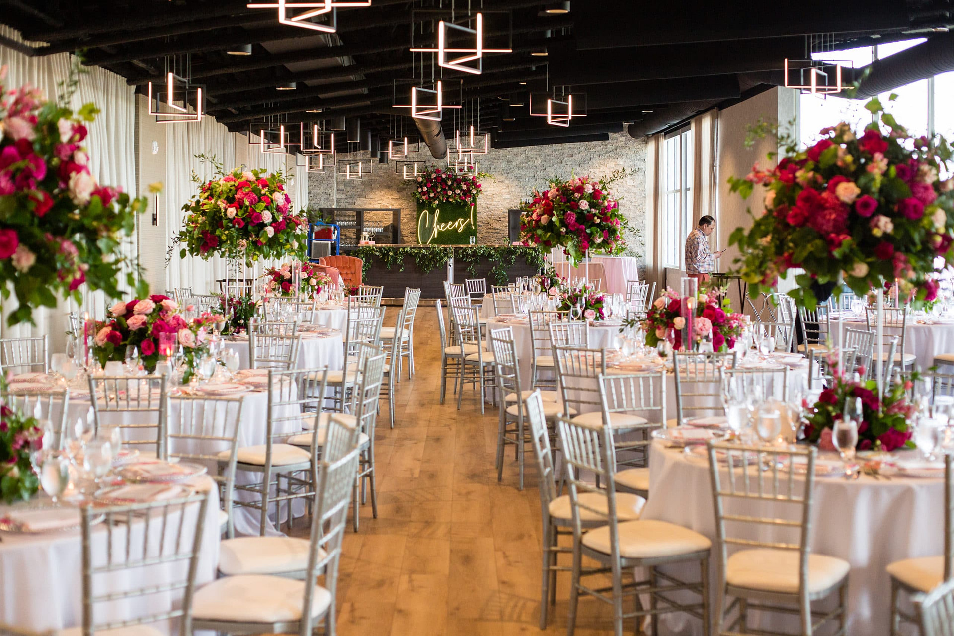 a dining room filled with furniture and vase of flowers on a table