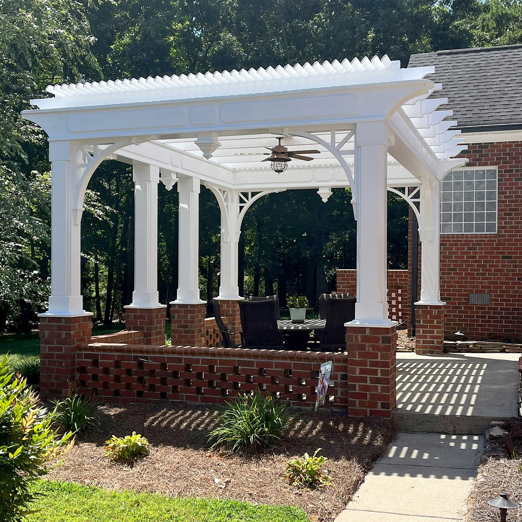 Custom vinyl pergola rafters and purlins on top of existing wood posts on a patio