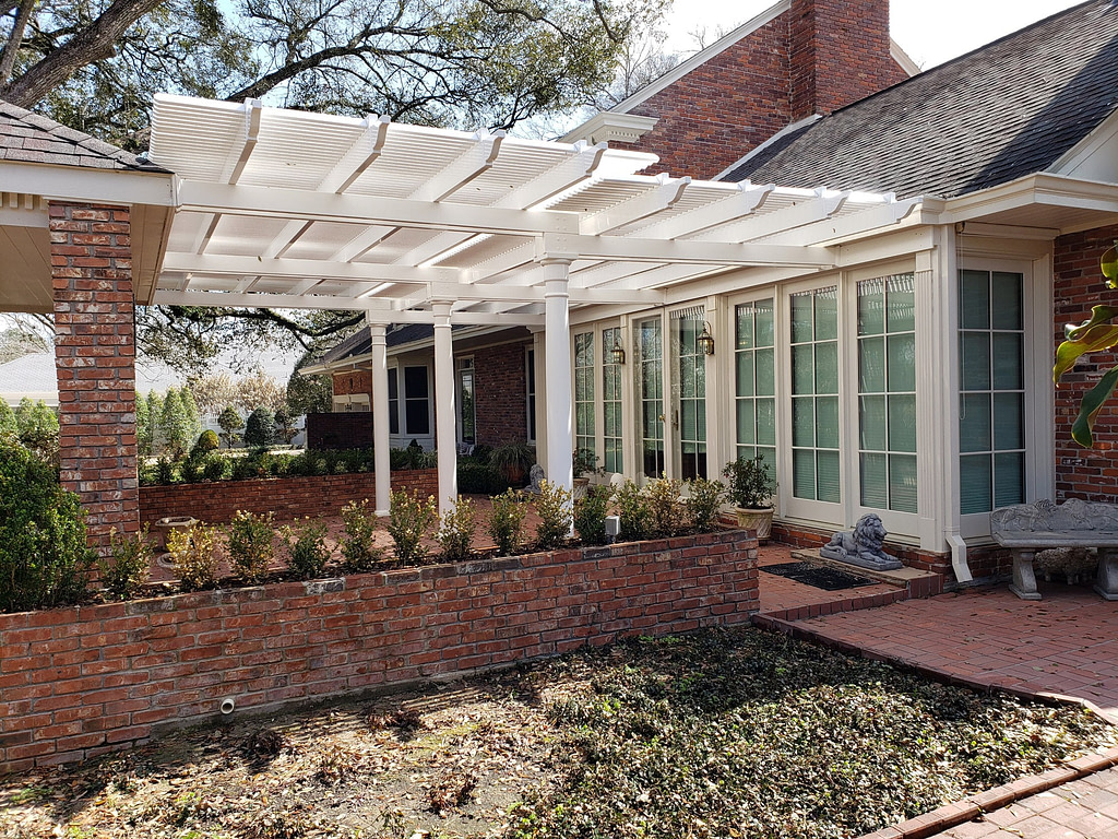 Custom two tier attached pergola in a courtyard