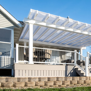White covered pergola over a large deck