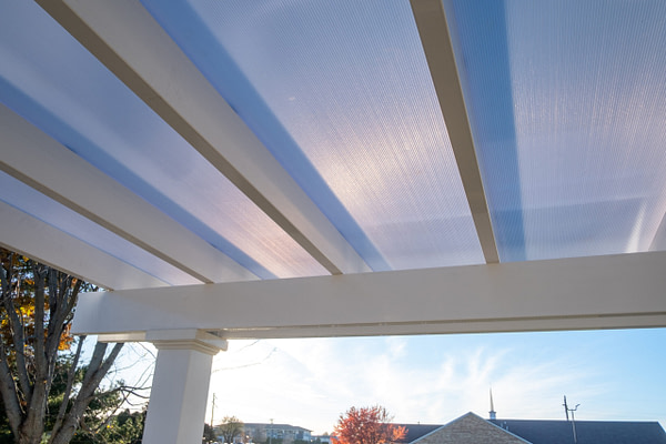 Close up view of white polycarbonate roof over a pergola