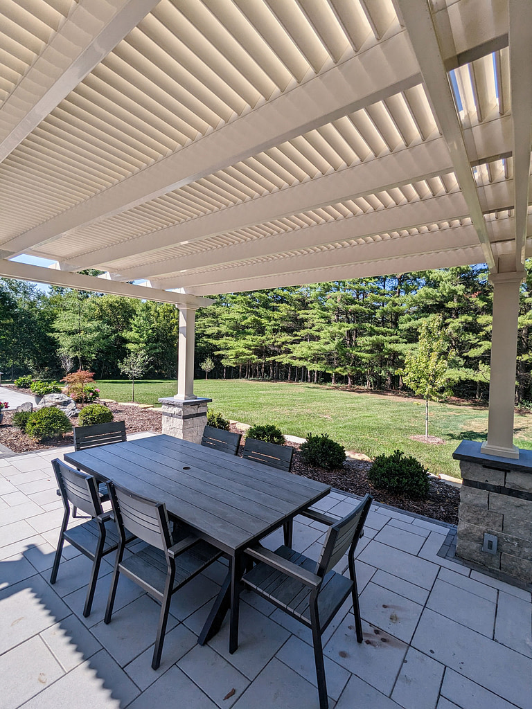 view from under a pergola with outdoor dining table