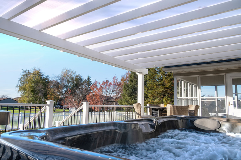 elements rain proof cover pergola over a hot tub and deck