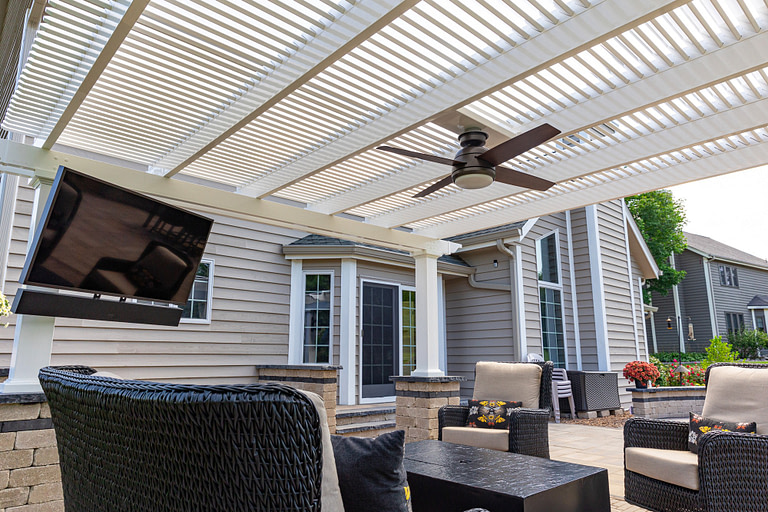 underside of outdoor pergola with fan and tv for patio seating
