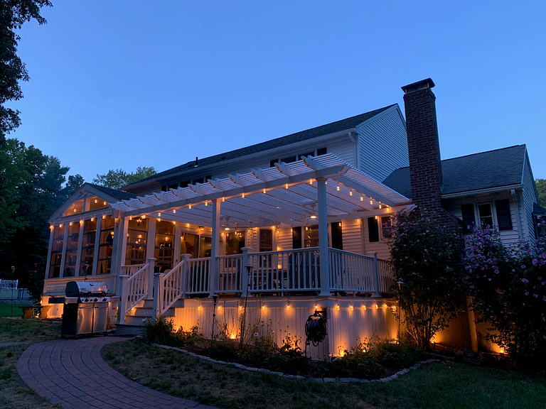 pergola over deck with string lights - cantina lights at night