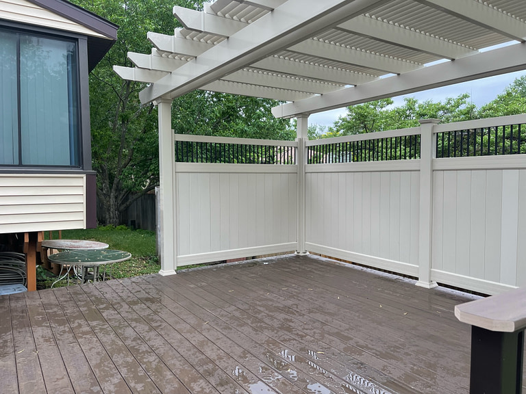 Vinyl privacy wall built on to a patio pergola