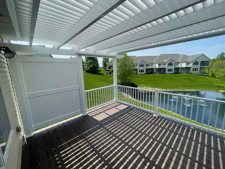 pergola over a deck with side vinyl privacy wall attached to the pergola.