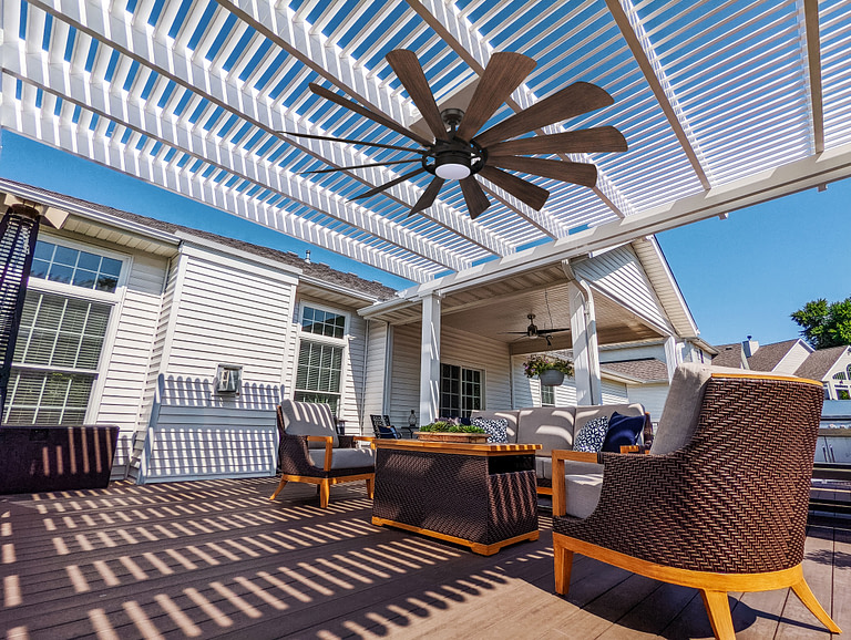 perspective on a deck under a shade pergola with outdoor fan and outdoor living seating
