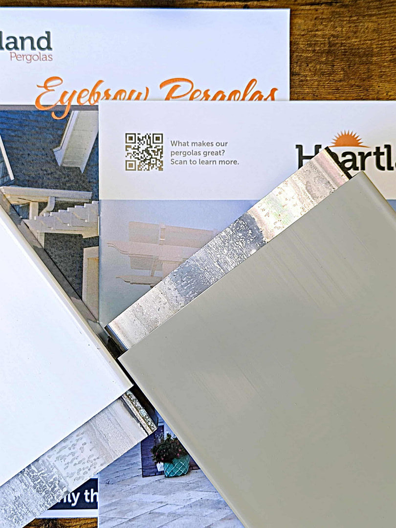 Sample pieces of aluminum and vinyl along with brochures for Heartland Pergolas
