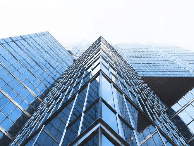 upwards view of skyscraper from sidewalk