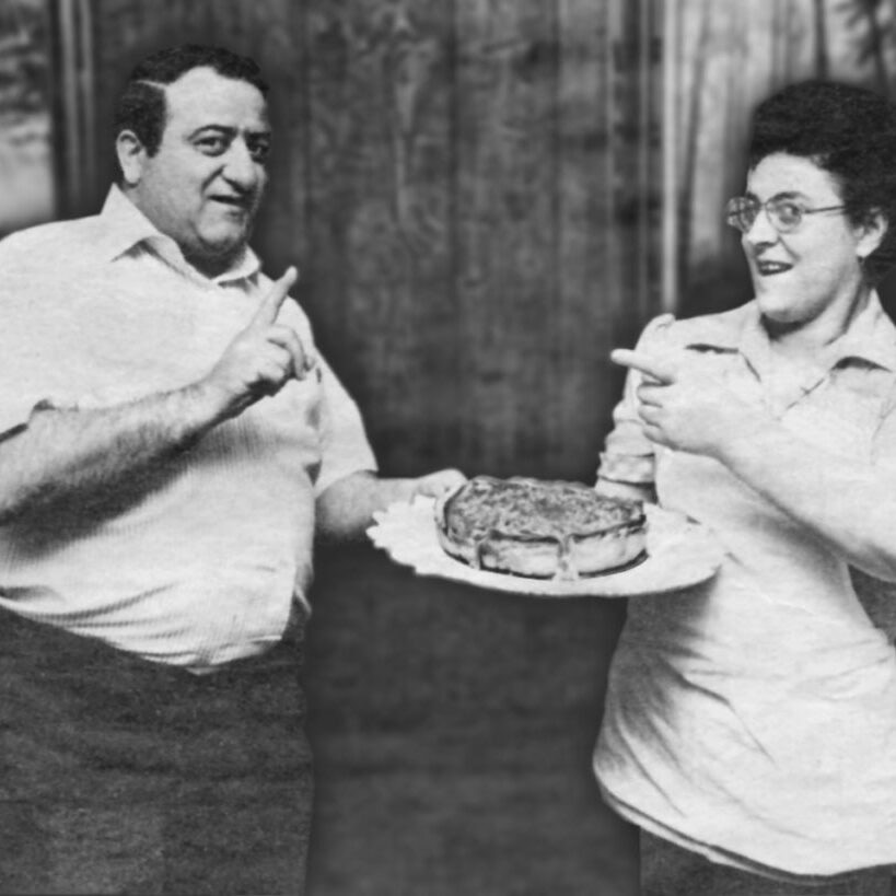 Nancy and Rocco Palese Holding a Stuffed Pizza