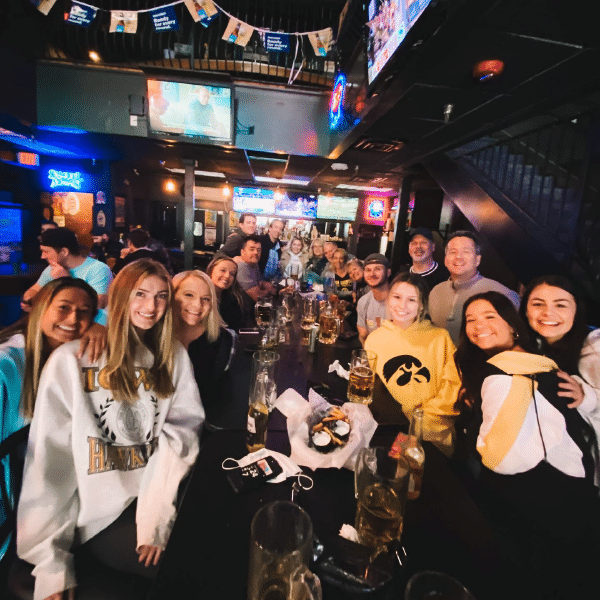 a group of people standing in front of a crowd posing for the camera