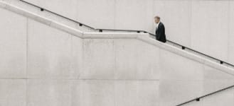 businessman walking up outdoor stairs