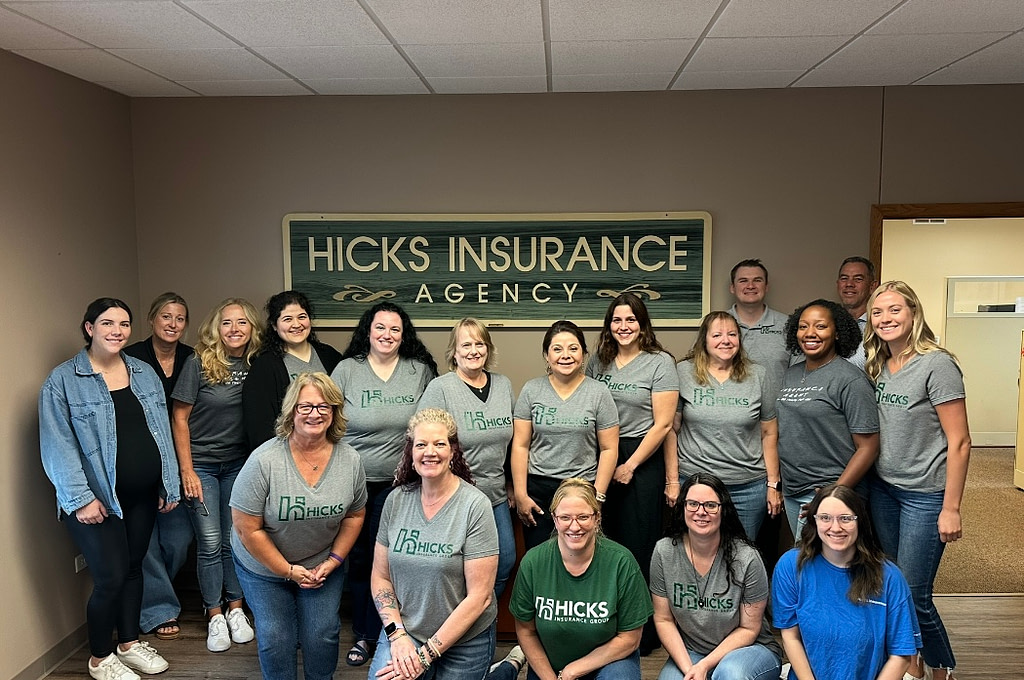 Group of Hicks Insurance Agency staff smiling in office
