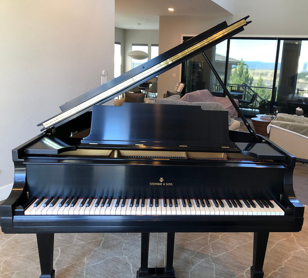 A piano sitting near a beautiful home's sitting room.