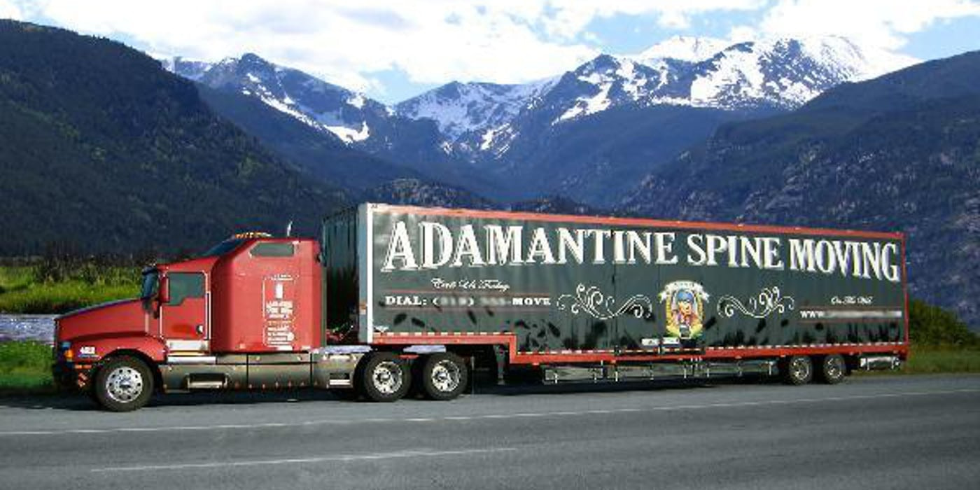 moving truck in front of mountain range