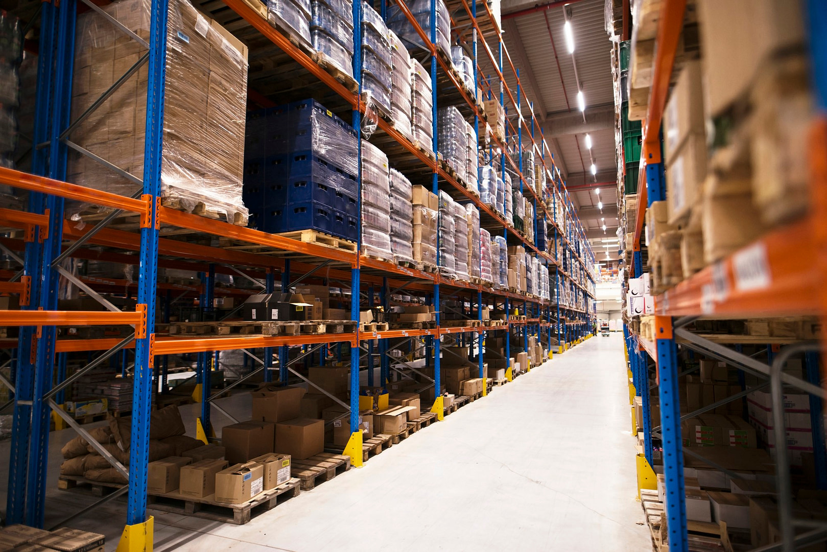 interior large distribution warehouse with shelves stacked with palettes goods ready market