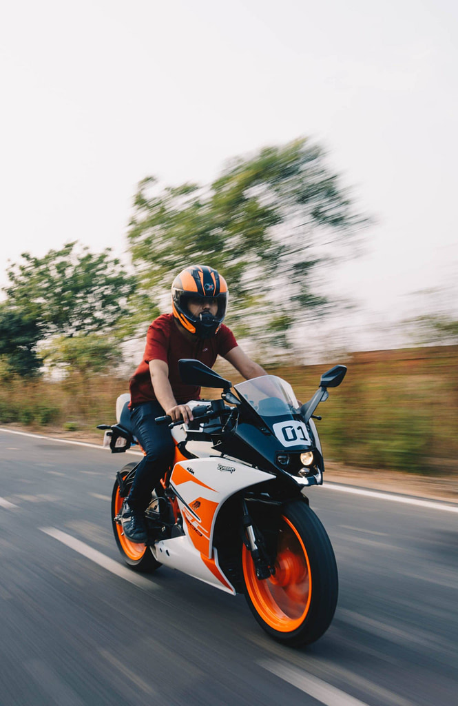 a man riding a motorcycle down a street