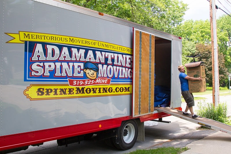 movers unload boxes from moving truck