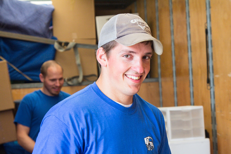 mover in blue shirt and hat smiling